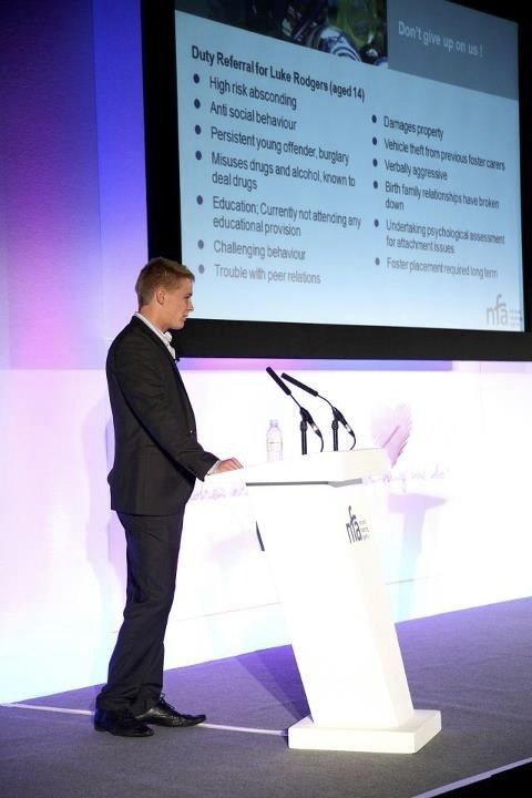 Luke presenting on a conference stage