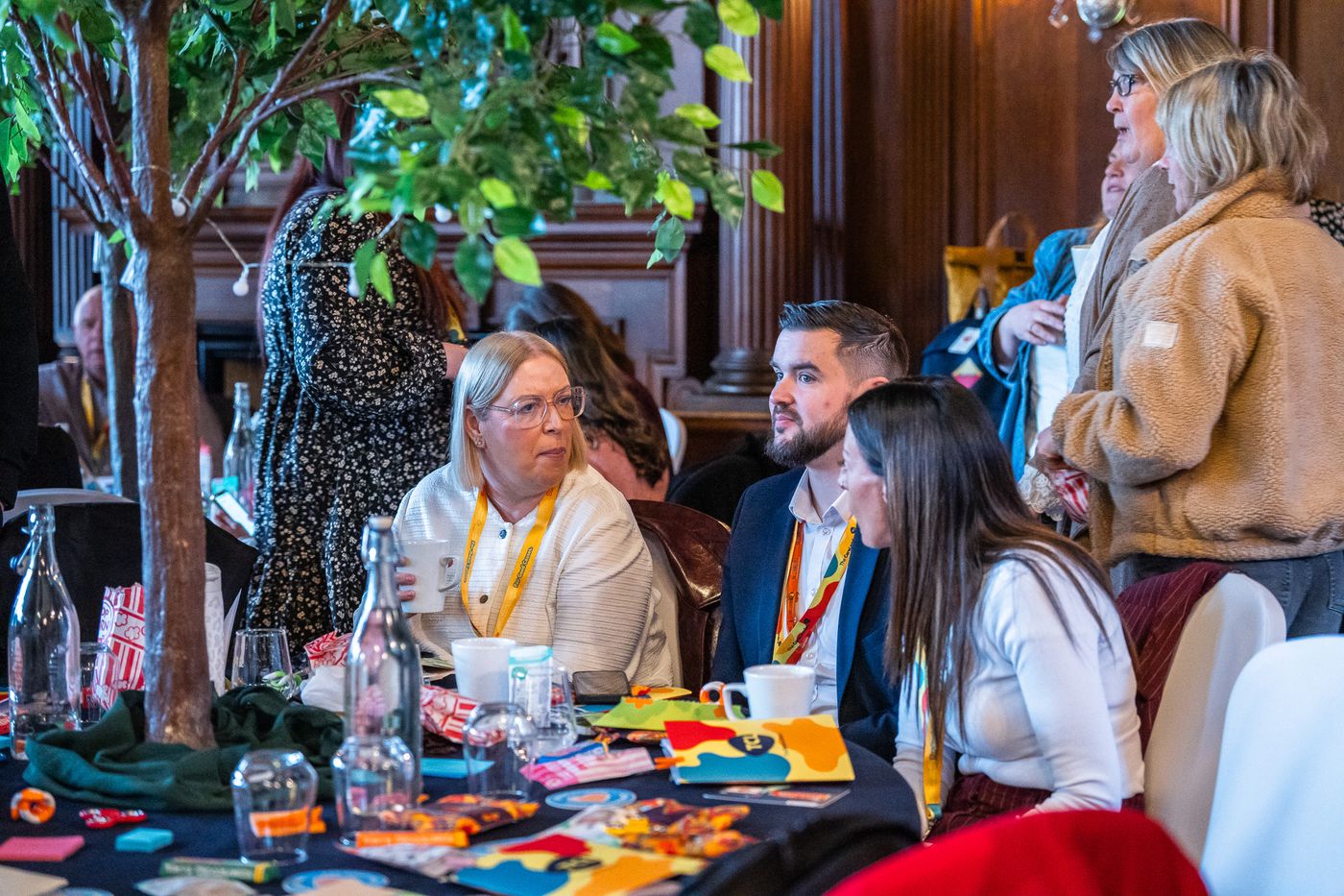 Delegates talking at a table with Summit notebooks